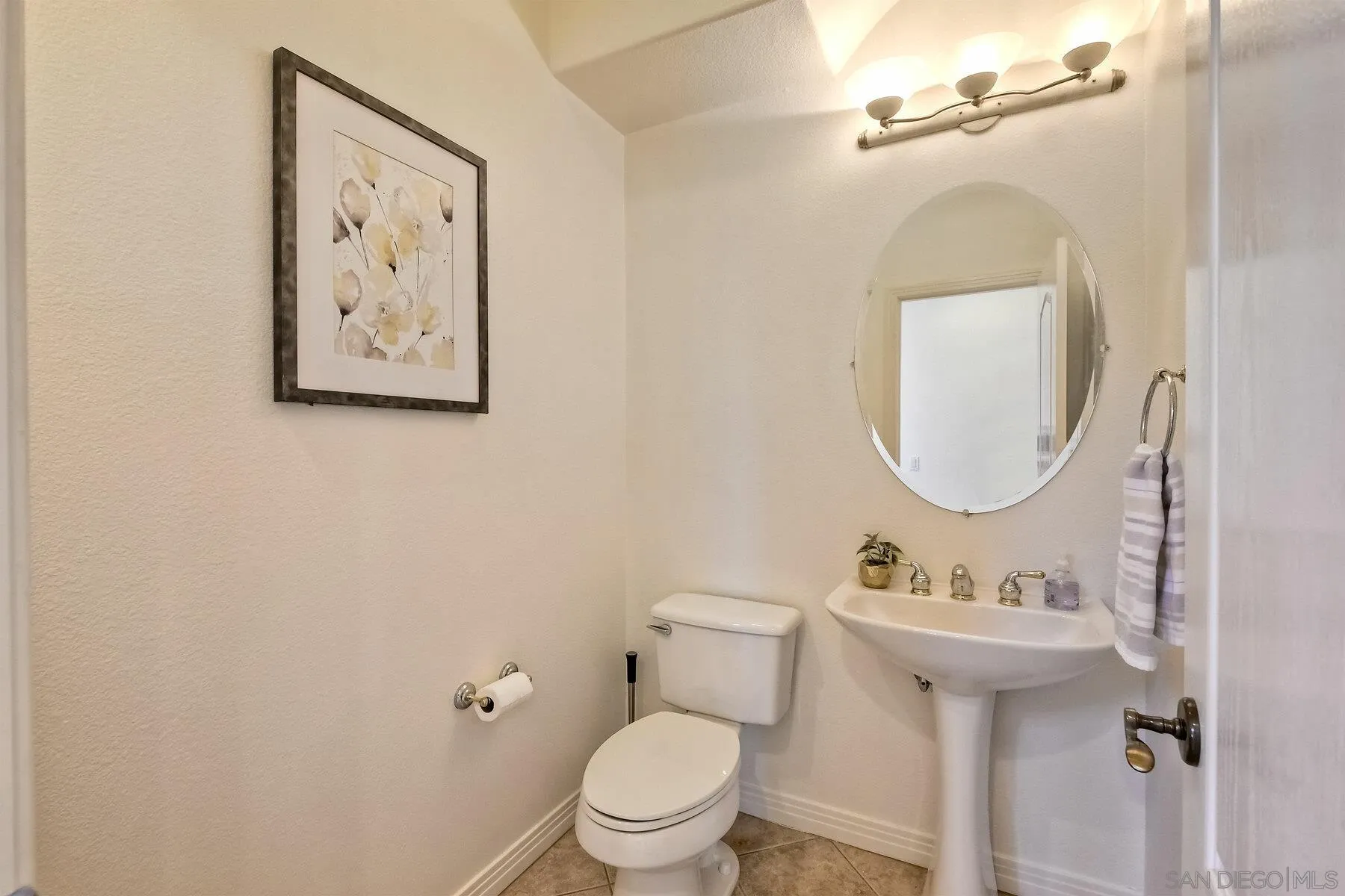 13660 Overland Pass Road Poway, CA 92064 - Photo 25 of 61 a bathroom with a toilet sink and mirror