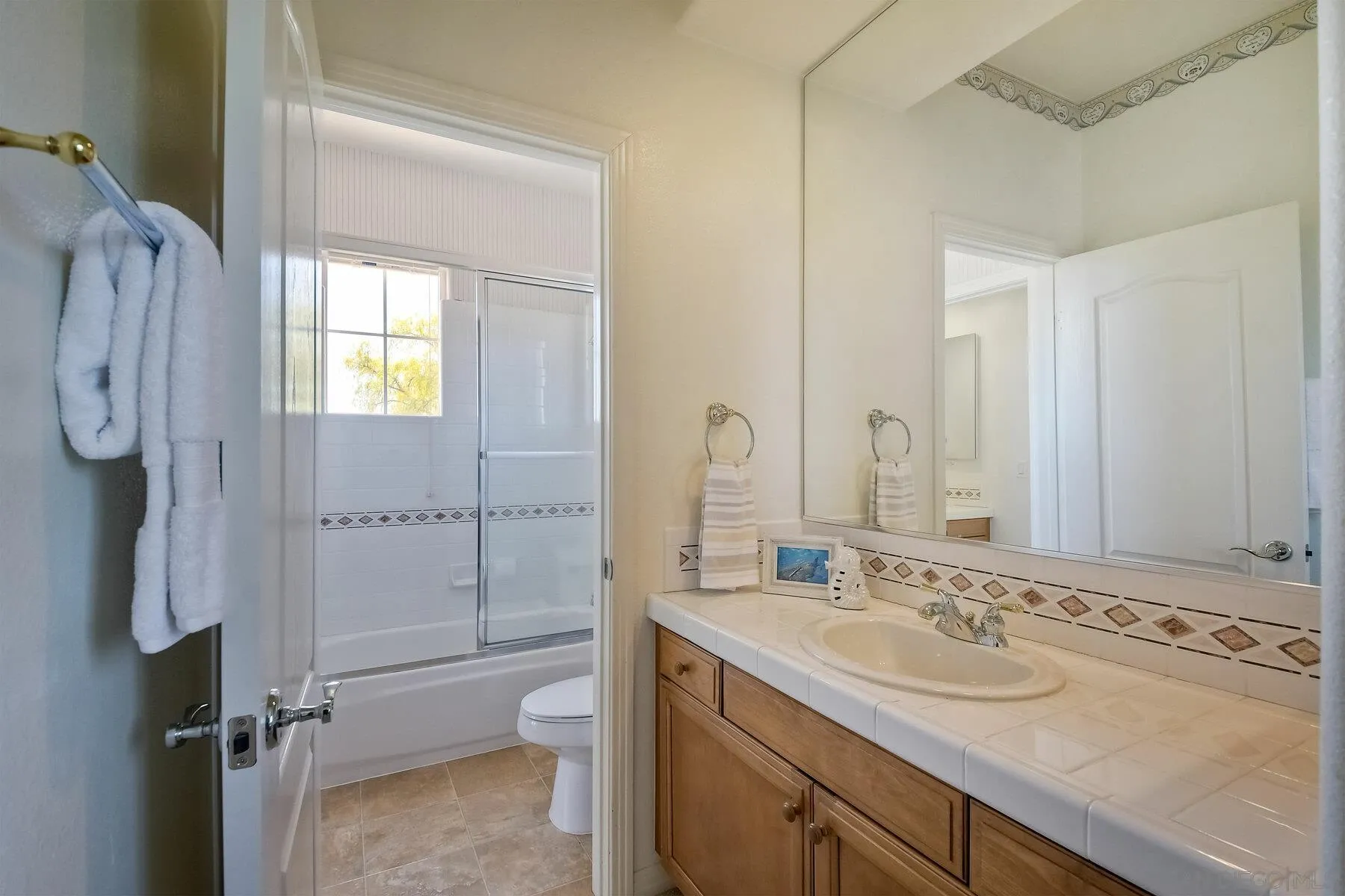 13660 Overland Pass Road Poway, CA 92064 - Photo 32 of 61 a bathroom with a granite countertop sink toilet and shower