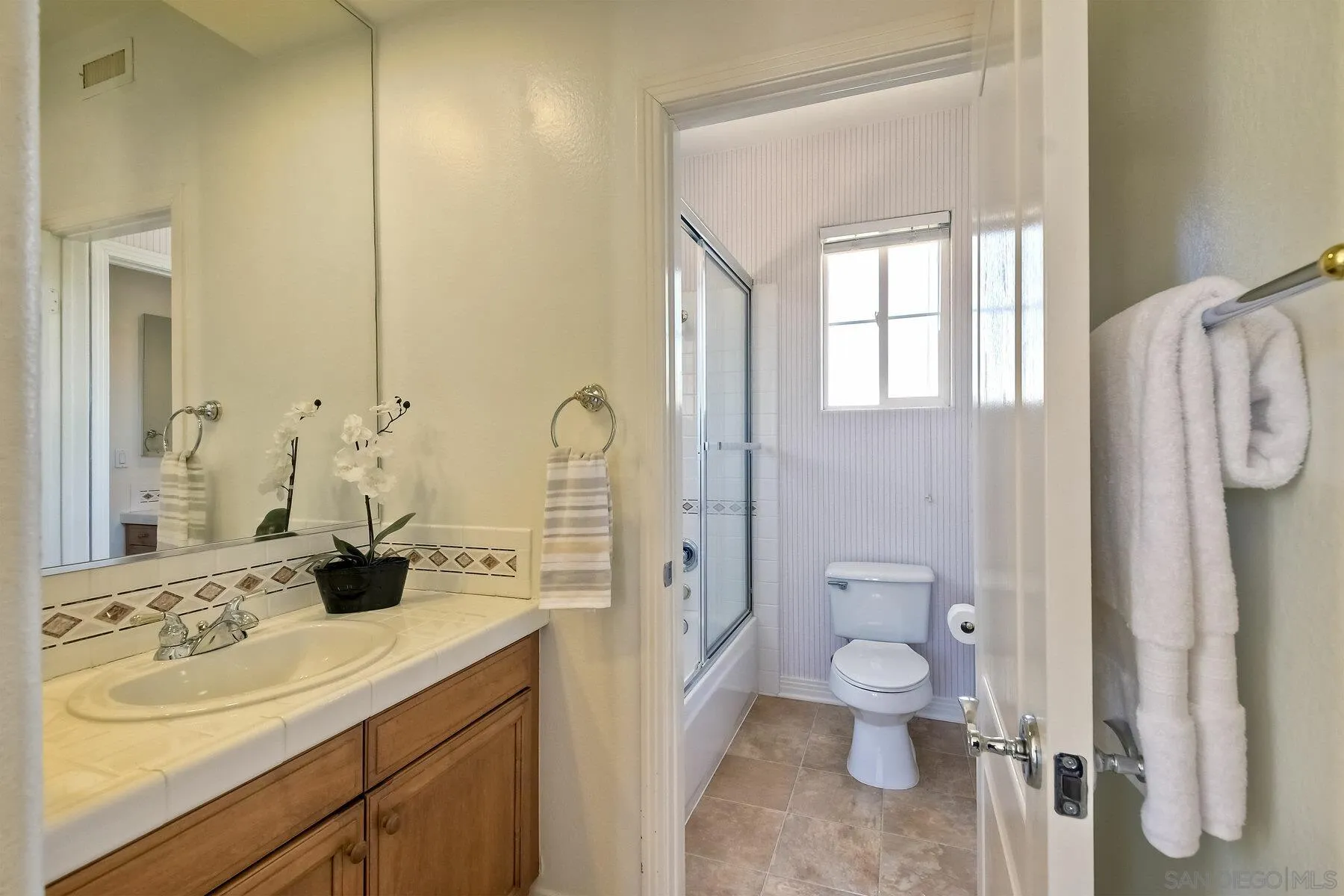 13660 Overland Pass Road Poway, CA 92064 - Photo 34 of 61 a spacious bathroom with a double vanity sink toilet and shower