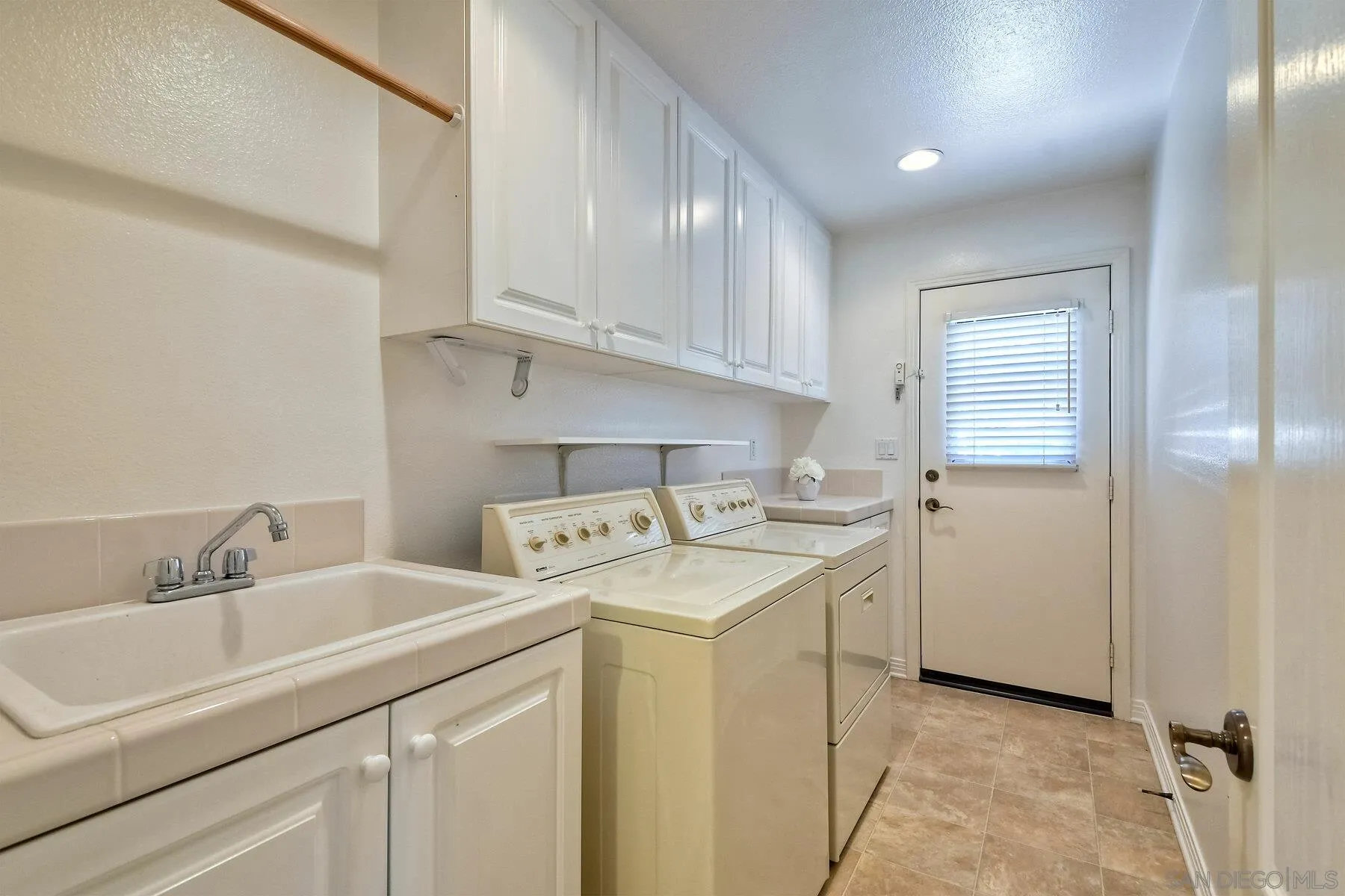 13660 Overland Pass Road Poway, CA 92064 - Photo 59 of 61 a utility room with cabinets washer and dryer