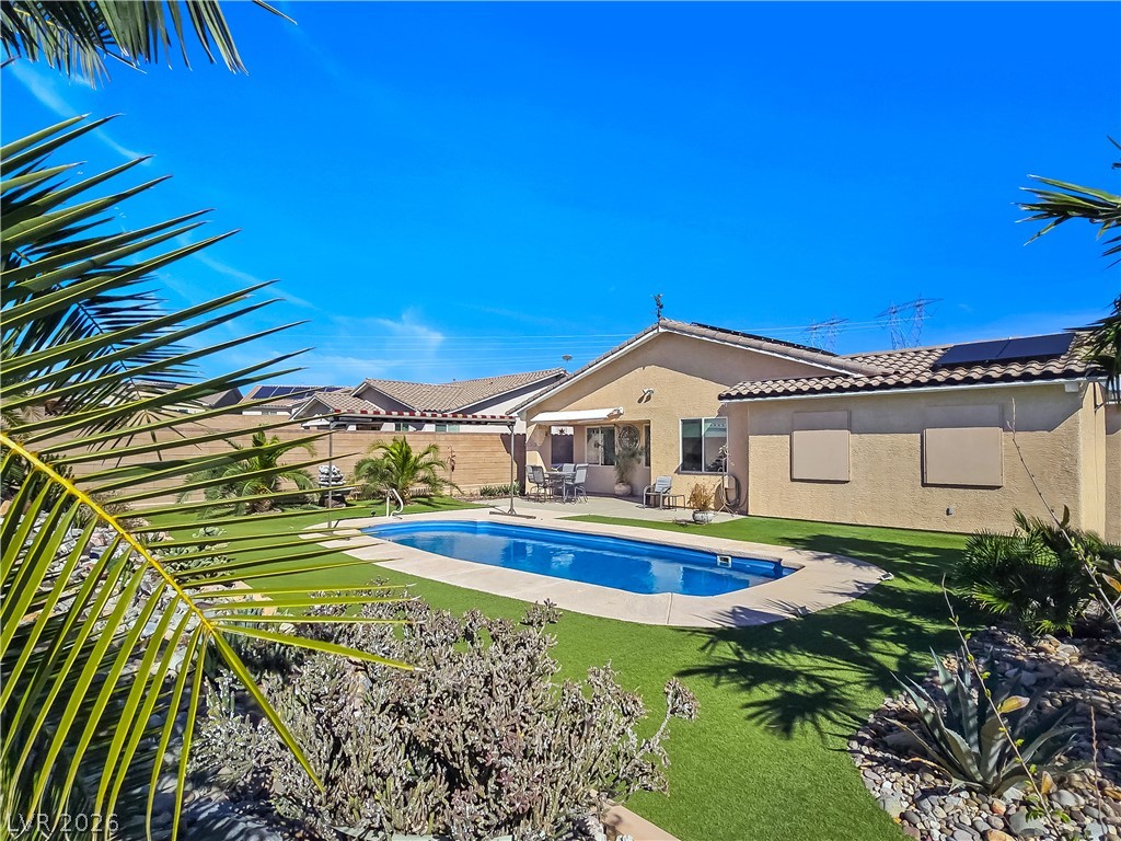2485 Morrow Ridge Place Laughlin, NV 89029 - Photo 34 of 40 An inviting backyard oasis offers a sparkling pool and lush, low-maintenance landscaping for endless enjoyment.
