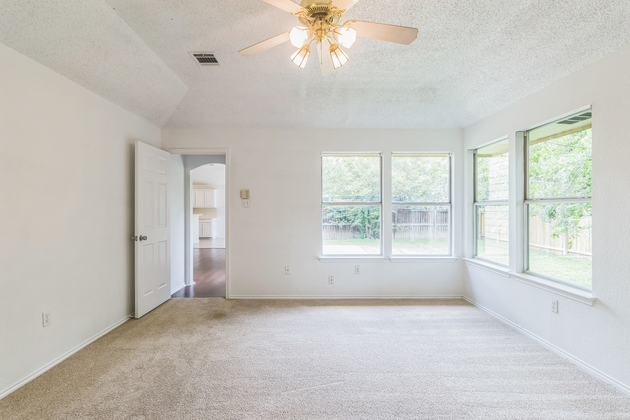 800 Mountain Ridge Drive Leander, TX 78641 - Photo 27 of 31 Plentiful windows fill this carpeted living space with natural light.