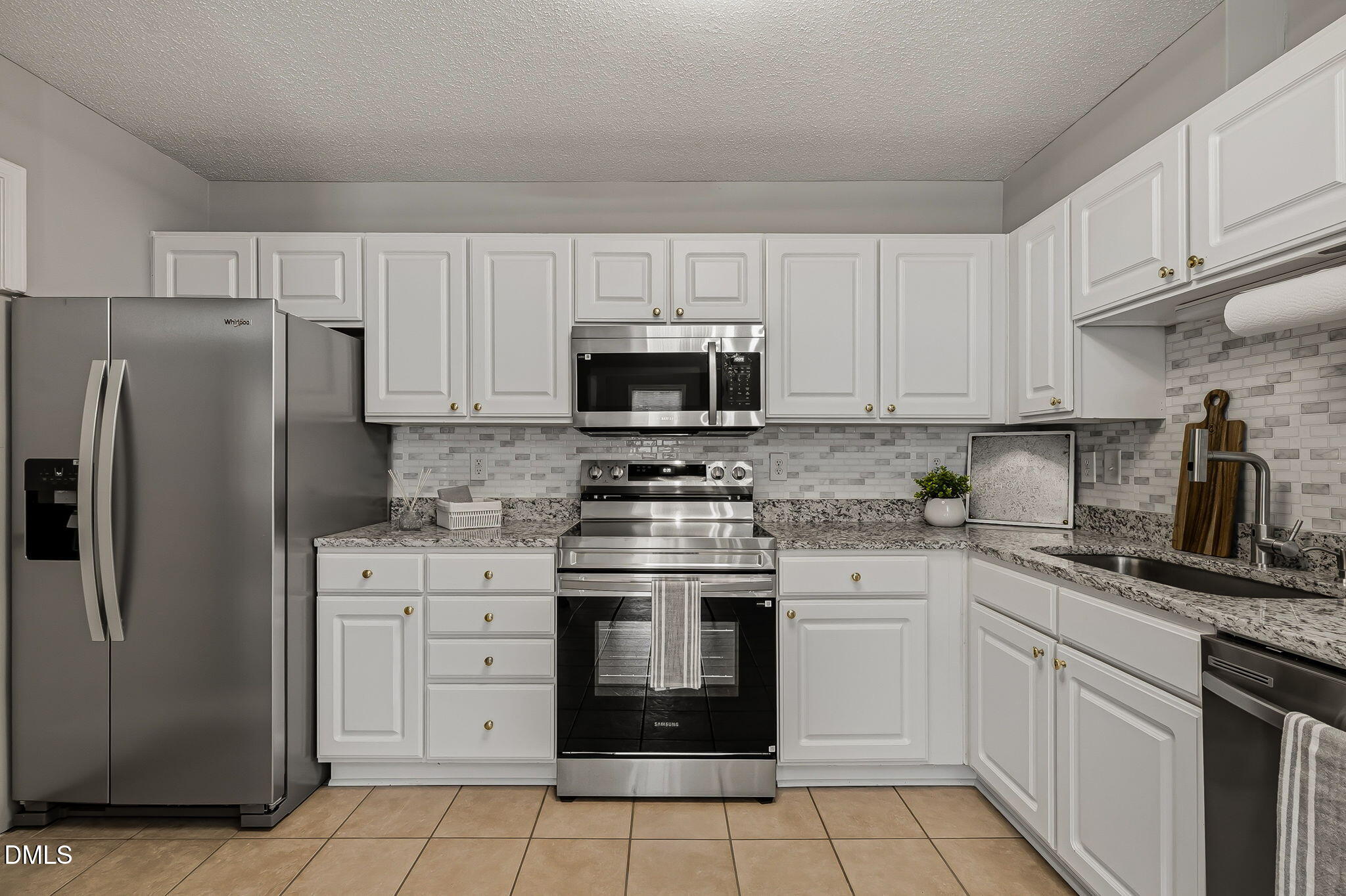 2501 Huntscroft Lane, Unit 100 Raleigh, NC 27617 - Photo 10 of 31 a kitchen with cabinets stainless steel appliances and sink