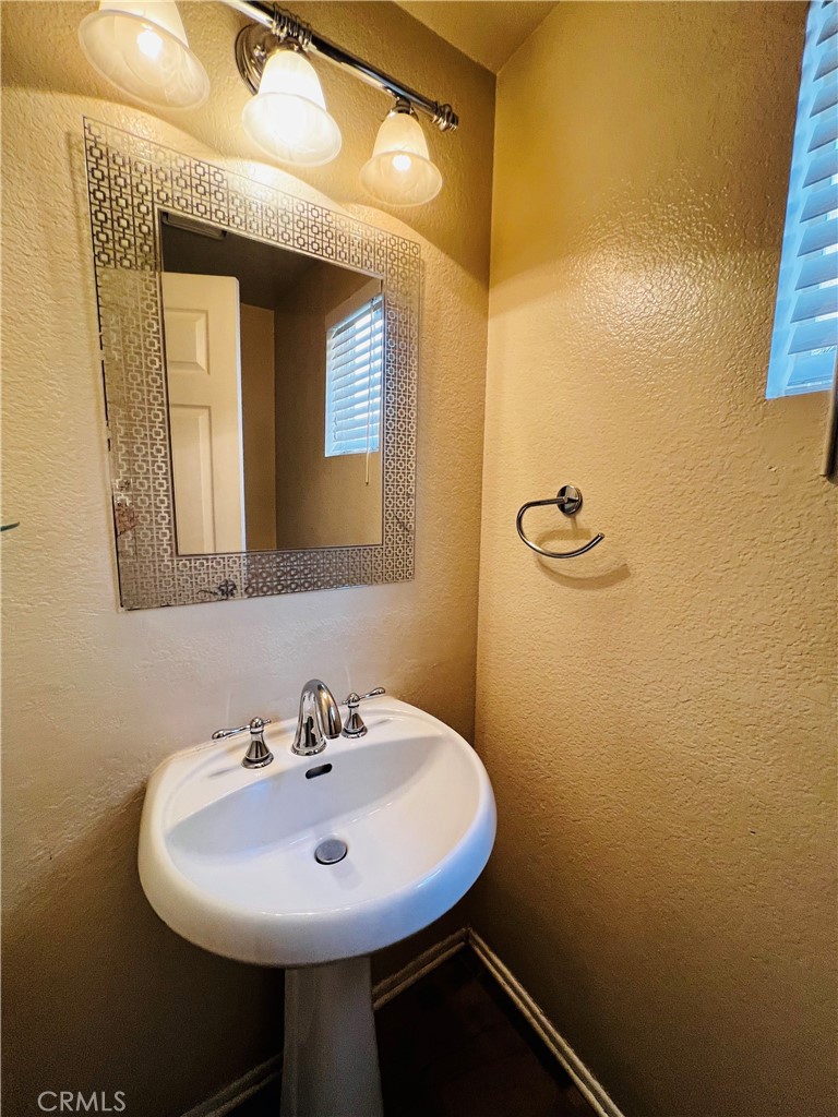 743 Orchard Loop Azusa, CA 91702 - Photo 19 of 38 a bathroom with a sink and a mirror