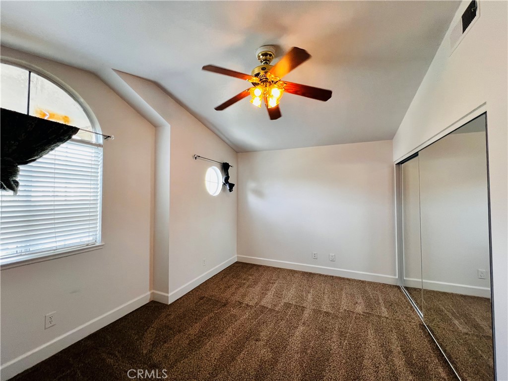 743 Orchard Loop Azusa, CA 91702 - Photo 22 of 38 a view of an empty room with window and wooden floor