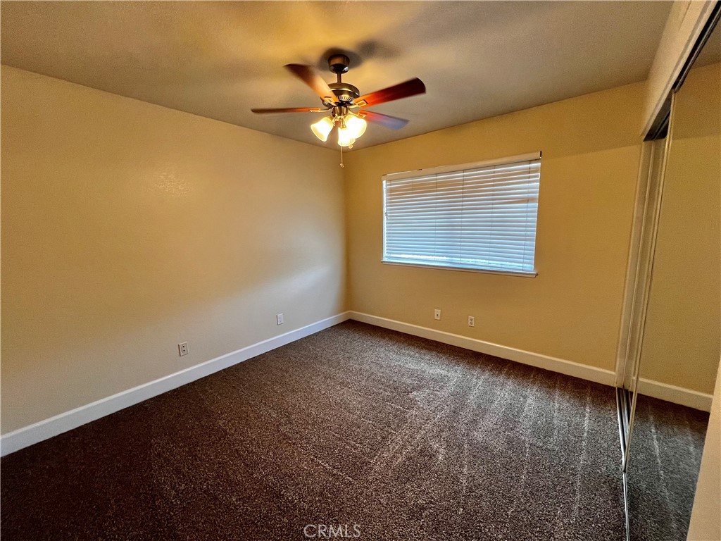 743 Orchard Loop Azusa, CA 91702 - Photo 23 of 38 a view of an empty room with wooden floor and a window