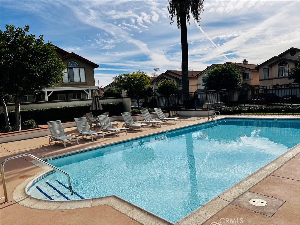 743 Orchard Loop Azusa, CA 91702 - Photo 35 of 38 a view of a swimming pool with a lounge chairs