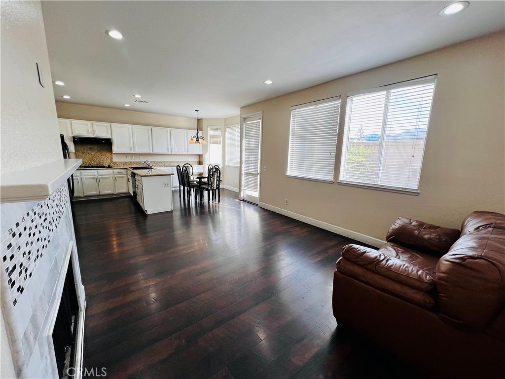 743 Orchard Loop Azusa, CA 91702 - Photo 7 of 38 a living room with furniture and a wooden floor