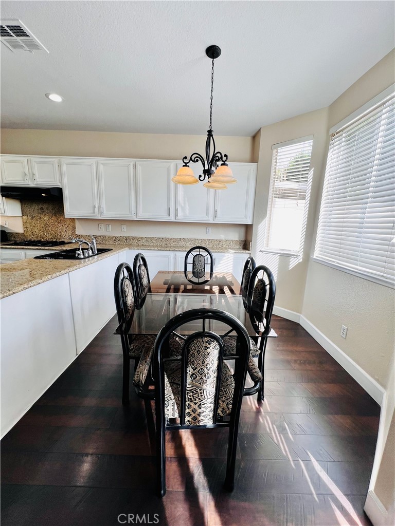 743 Orchard Loop Azusa, CA 91702 - Photo 9 of 38 a view of a dining room with furniture window and wooden floor