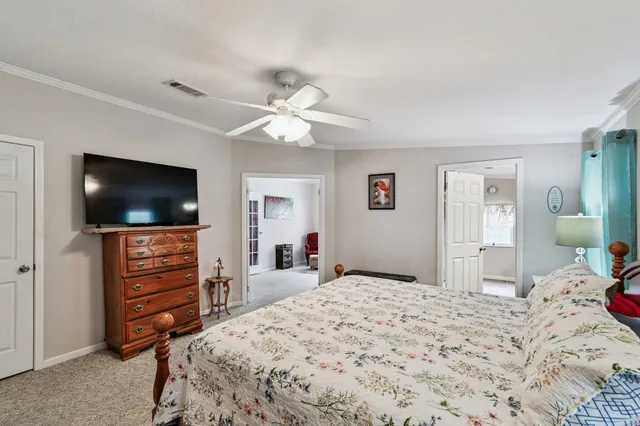 a view of a house with a big yard and large trees
