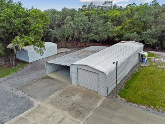 a front view of a house with a garden and yard