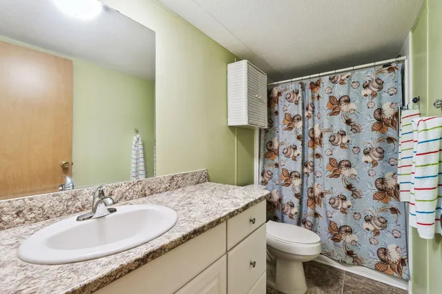 a aerial view of a house with a yard and lake view