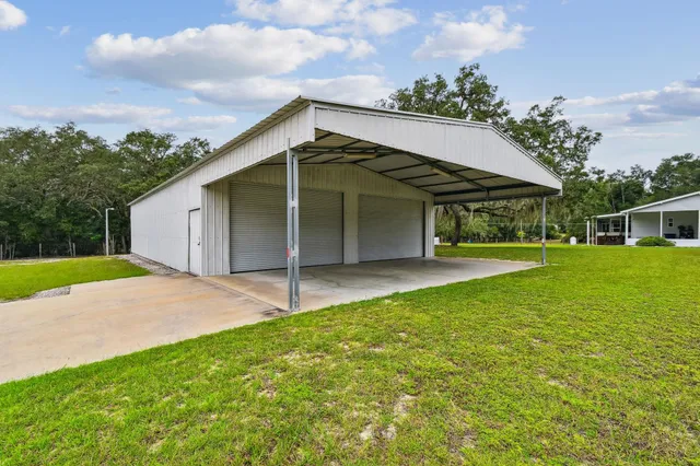 a view of a house with backyard and balcony