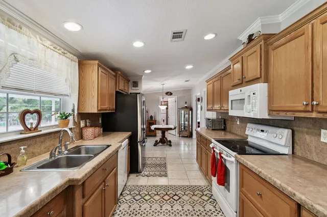 a view of a dining room with furniture a chandelier and wooden floor