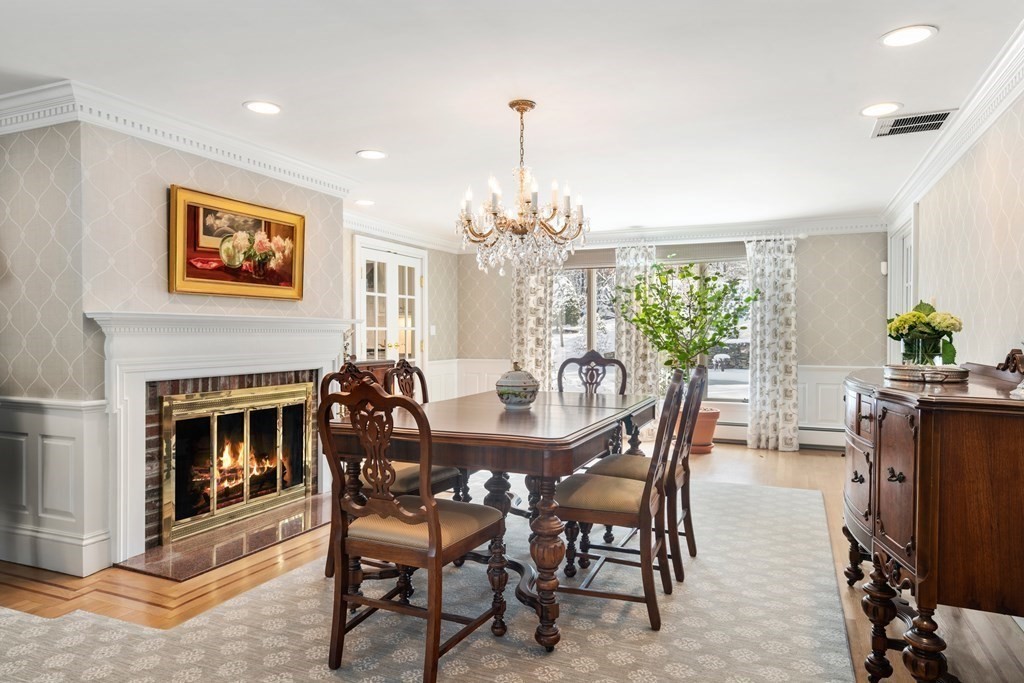 22 Hillcrest Road Weston, MA 02493 - Photo 13 of 31 a dining room with furniture potted plants and a fireplace