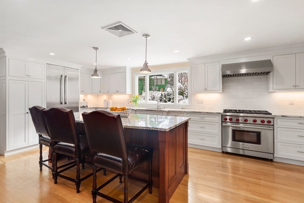 22 Hillcrest Road Weston, MA 02493 - Photo 7 of 31 a kitchen with a stove a table and chairs in it