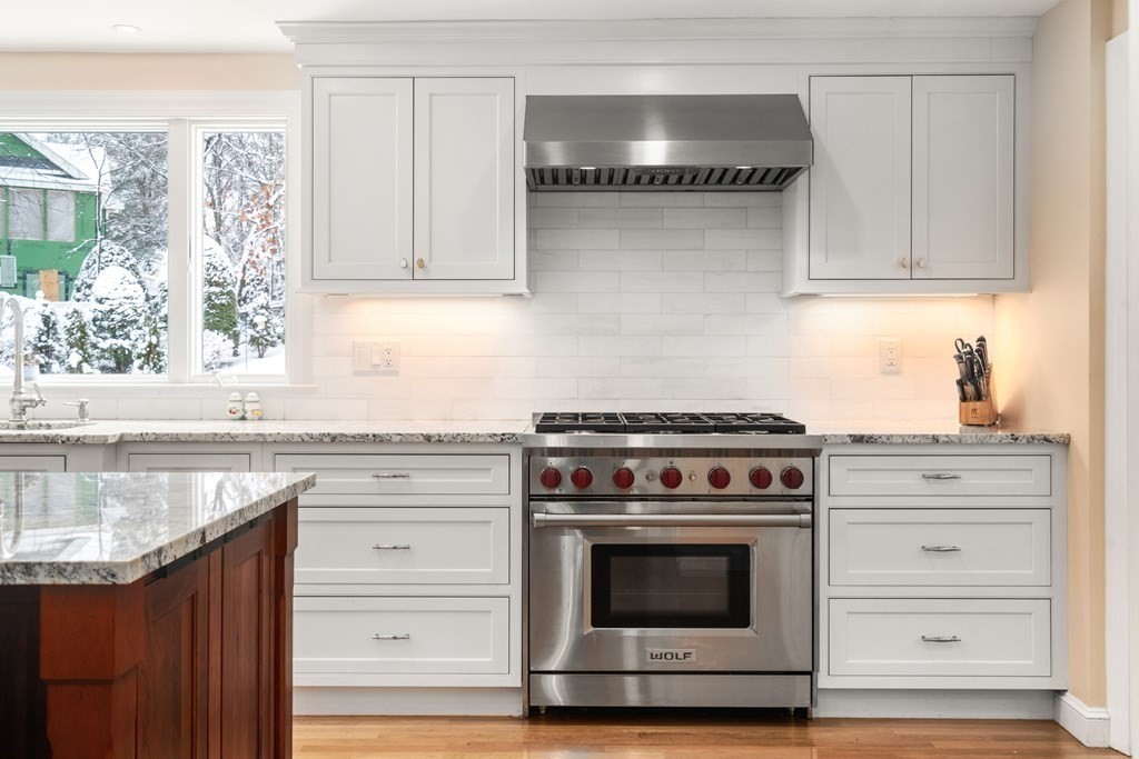 22 Hillcrest Road Weston, MA 02493 - Photo 8 of 31 a kitchen with stainless steel appliances granite countertop a stove and a sink