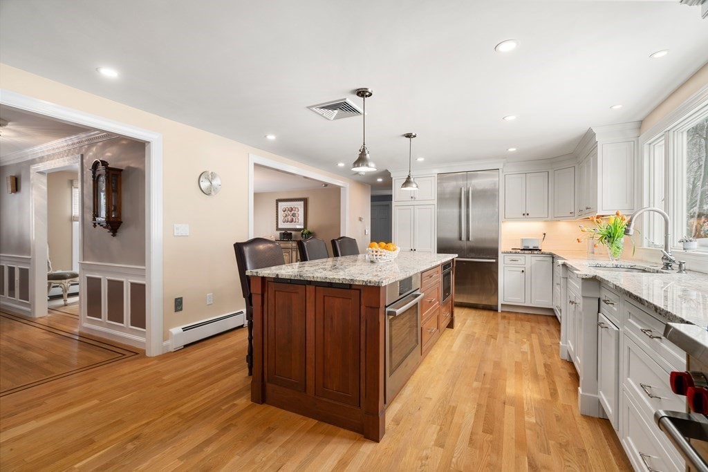 22 Hillcrest Road Weston, MA 02493 - Photo 9 of 31 a large kitchen with stainless steel appliances granite countertop a lot of counter space and wooden floors