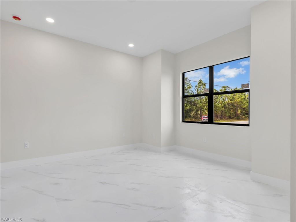 350 Delaware Road Lehigh Acres, FL 33936 - Photo 24 of 30 an empty room with windows