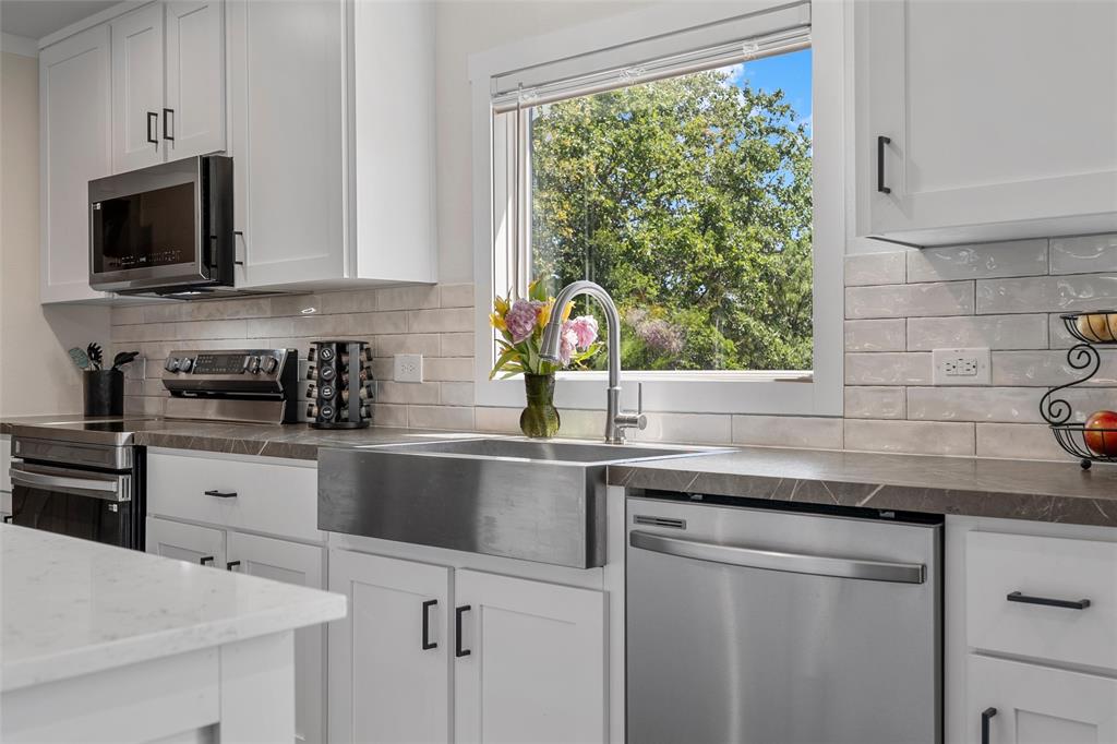 3050 Clater Powell Road Waco, TX 76705 - Photo 17 of 39 a kitchen with stainless steel appliances white cabinets and a sink