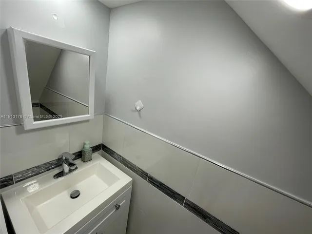 a bathroom with a sink and mirror