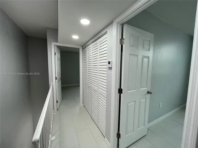 a view of a hallway with closet and entryway