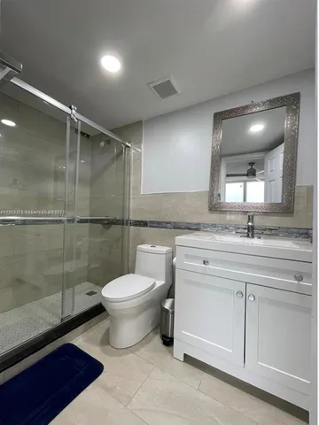 a bathroom with a toilet sink and a shower