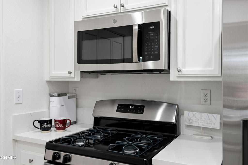 4427 Antigua Way Oxnard, CA 93035 - Photo 13 of 43 a kitchen with a stove and a microwave
