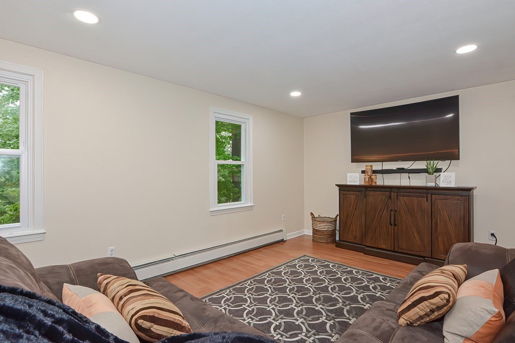 7 Proctor Road Pepperell, MA 01463 - Photo 11 of 40 a living room with furniture and a flat screen tv