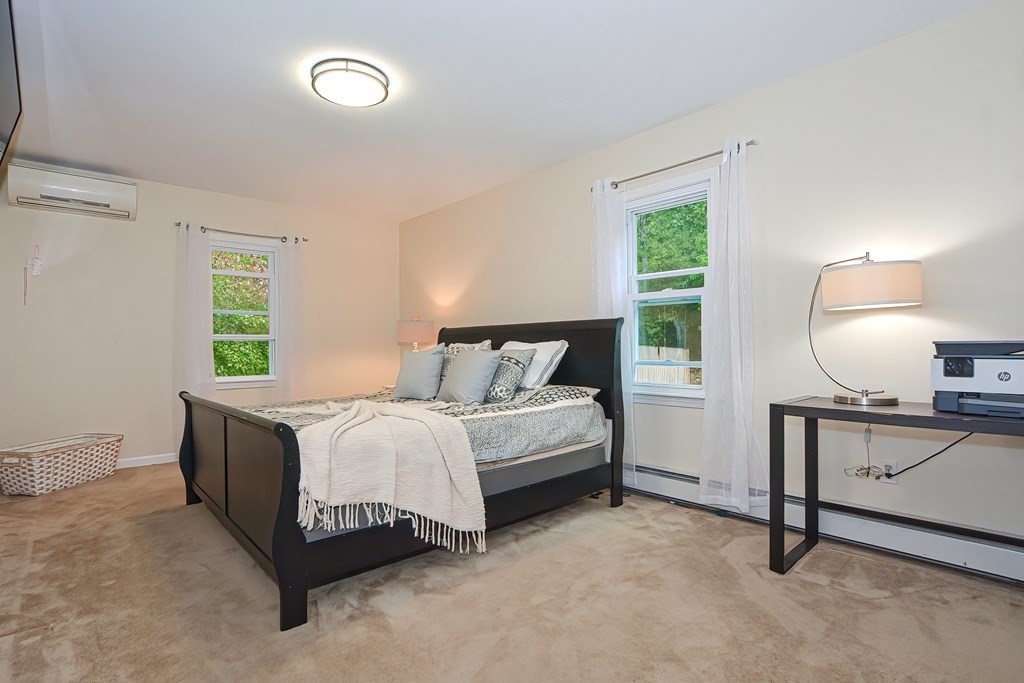 7 Proctor Road Pepperell, MA 01463 - Photo 17 of 40 a bed room with a bed and a lamp