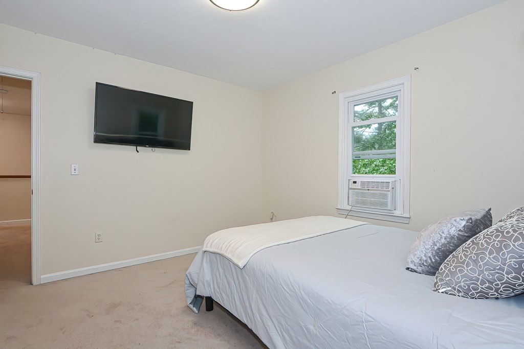 7 Proctor Road Pepperell, MA 01463 - Photo 23 of 40 a bedroom with a flat screen tv and a window