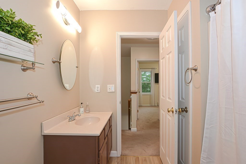 7 Proctor Road Pepperell, MA 01463 - Photo 24 of 40 a bathroom with a sink mirror and shower
