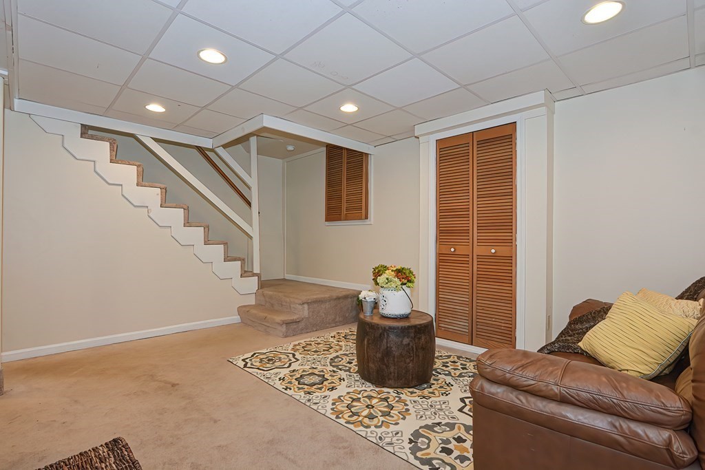 7 Proctor Road Pepperell, MA 01463 - Photo 25 of 40 a living room with furniture and a potted plant