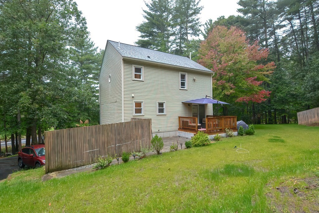 7 Proctor Road Pepperell, MA 01463 - Photo 38 of 40 a view of backyard with table and chairs and wooden fence