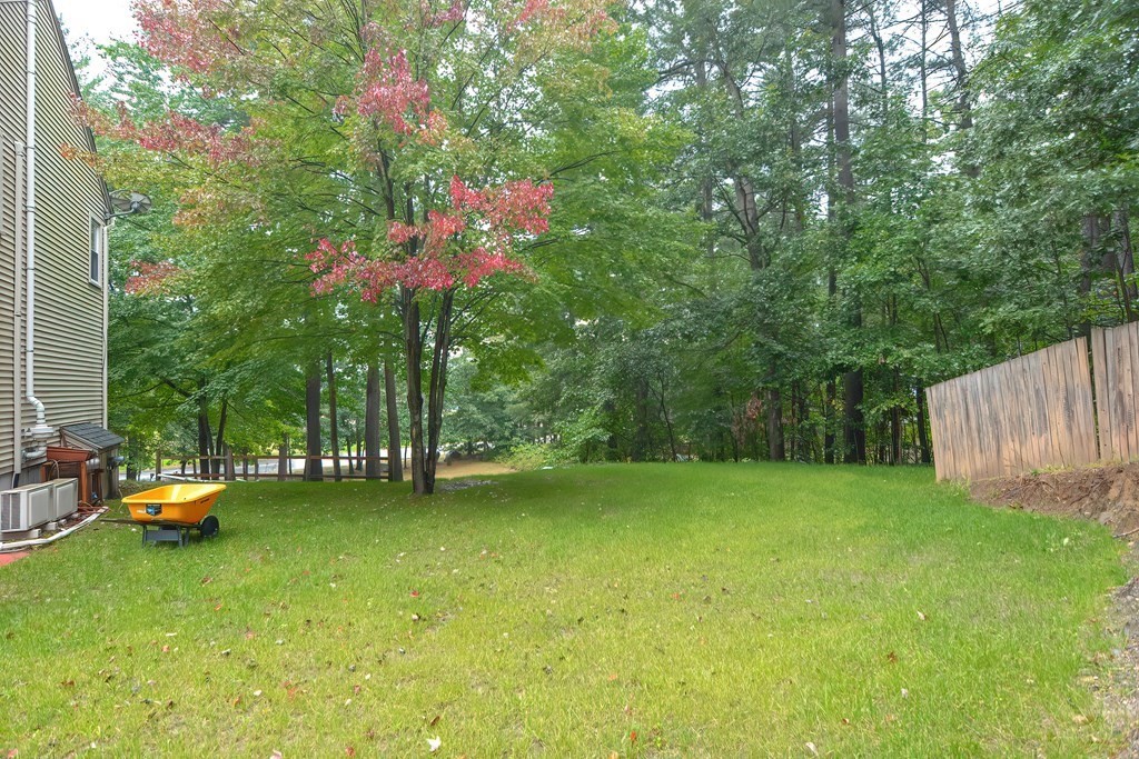7 Proctor Road Pepperell, MA 01463 - Photo 40 of 40 a backyard of a house with table and chairs
