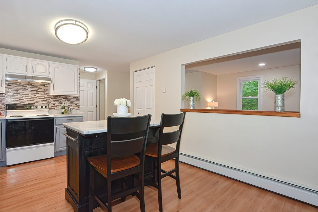 7 Proctor Road Pepperell, MA 01463 - Photo 6 of 40 a view of a dining room with furniture and wooden floor
