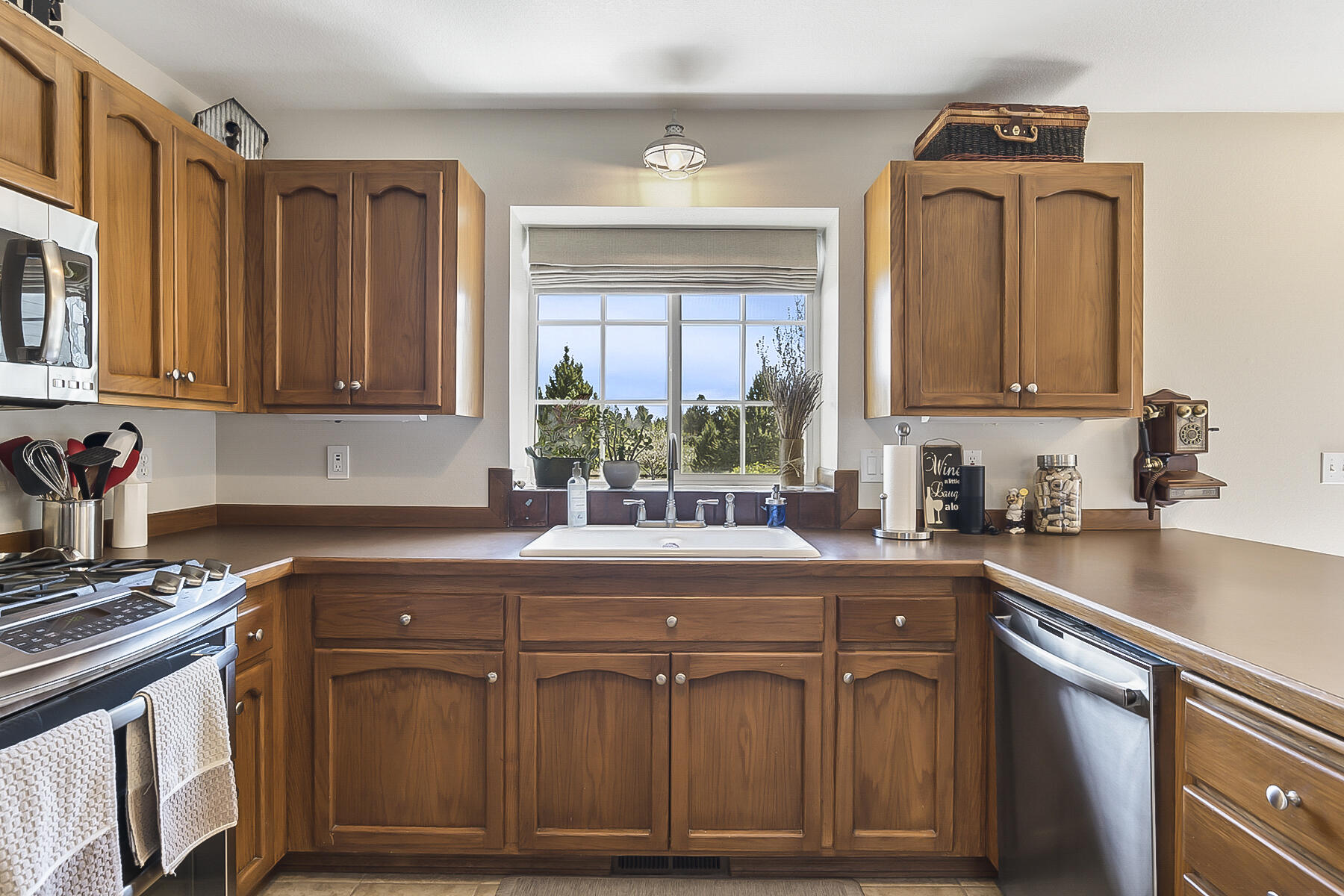 61030 Jennings Road Bend, OR 97702 - Photo 21 of 76 a kitchen with stainless steel appliances granite countertop a sink stove and cabinets
