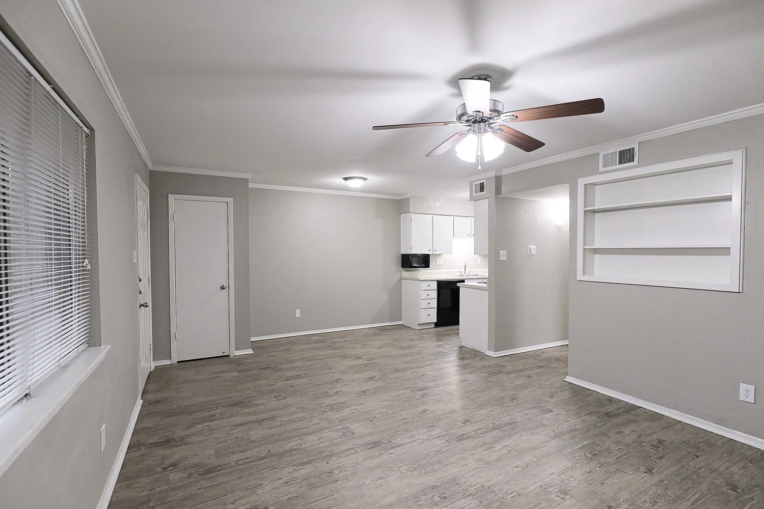 8100 North Mopac Expressway, Unit 2108 Austin, TX 78759 - Photo 11 of 23 Unfurnished living room with ornamental molding, built in features, wood finished floors, and a ceiling fan