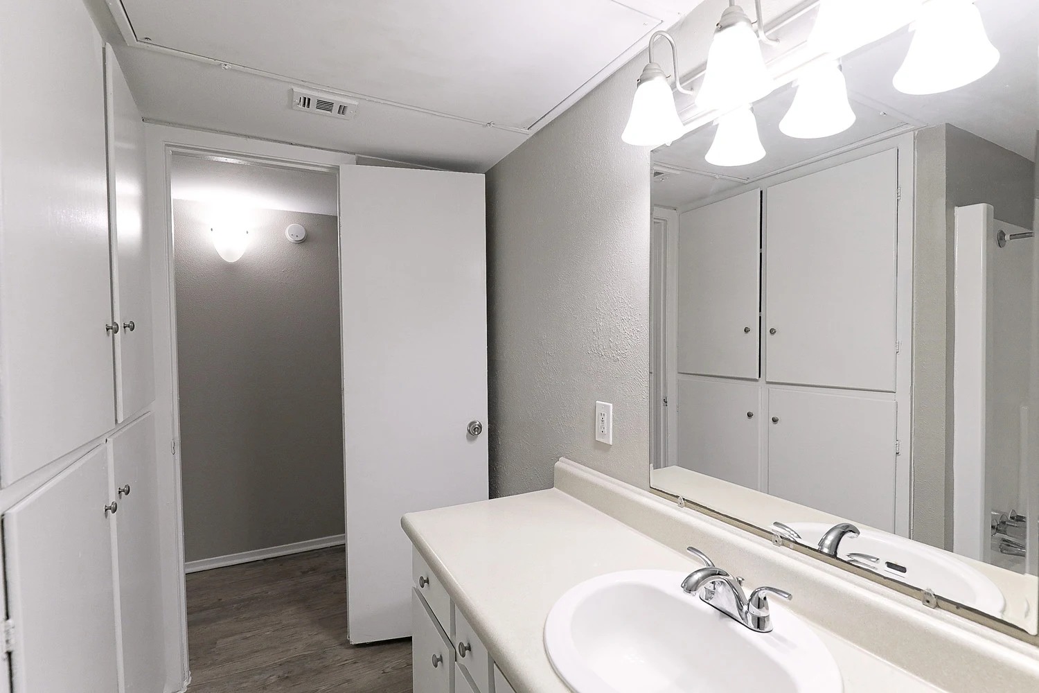 8100 North Mopac Expressway, Unit 2108 Austin, TX 78759 - Photo 18 of 23 Bathroom with vanity, a shower with curtain, light wood-type flooring, and a textured wall