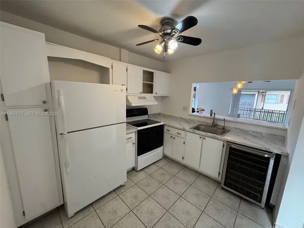 a kitchen with a sink a stove cabinets and stainless steel appliances