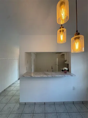 a view of empty room with wooden floor and window