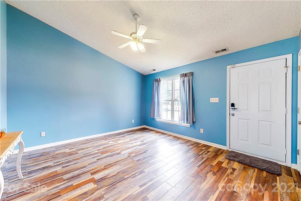4262 Barley Street Southwest Concord, NC 28027 - Photo 12 of 27 a view of a room with wooden floor and fan