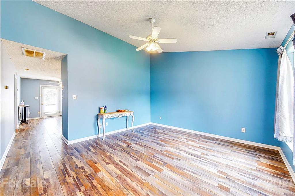 4262 Barley Street Southwest Concord, NC 28027 - Photo 13 of 27 a view of a room with wooden floor and ceiling fan