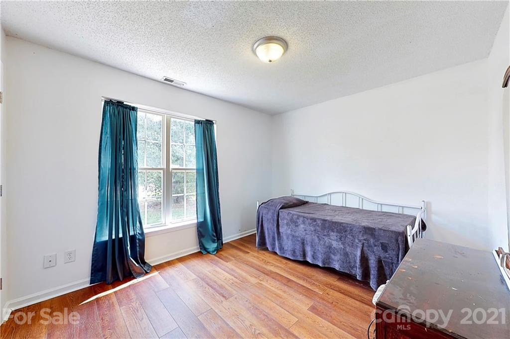 4262 Barley Street Southwest Concord, NC 28027 - Photo 17 of 27 a bedroom with a bed and a large window