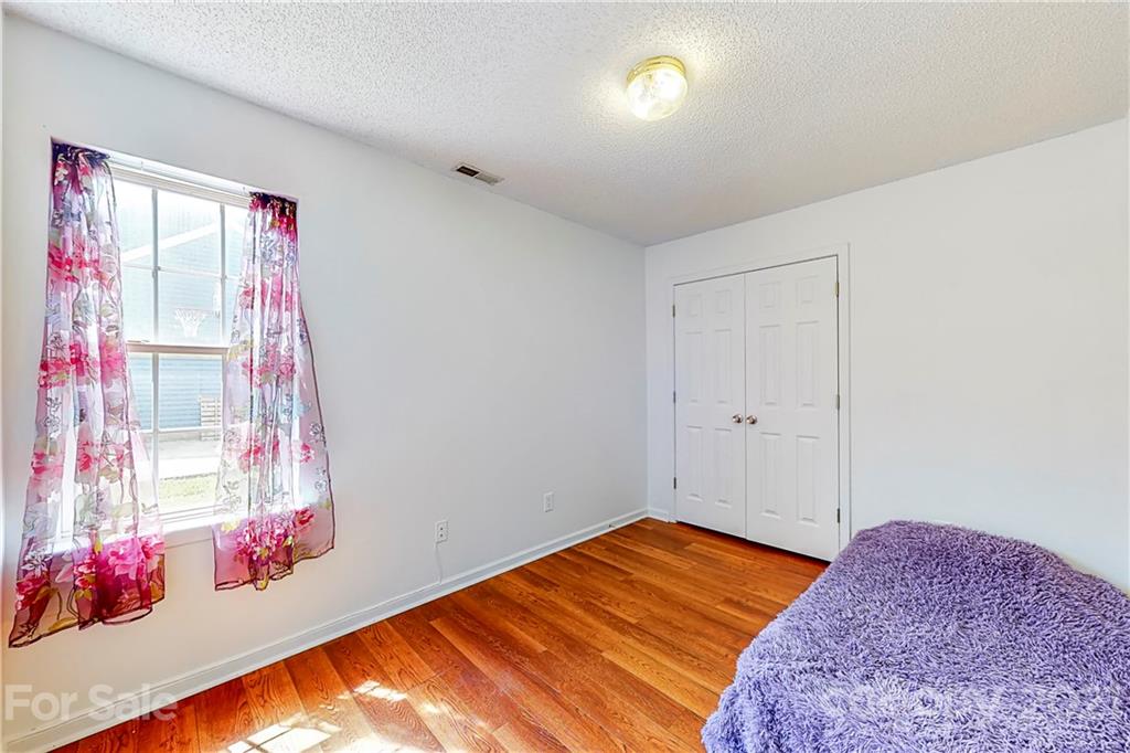 4262 Barley Street Southwest Concord, NC 28027 - Photo 19 of 27 a bedroom with a bed and a window