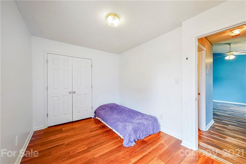 4262 Barley Street Southwest Concord, NC 28027 - Photo 20 of 27 a bedroom with a bed and wooden floor
