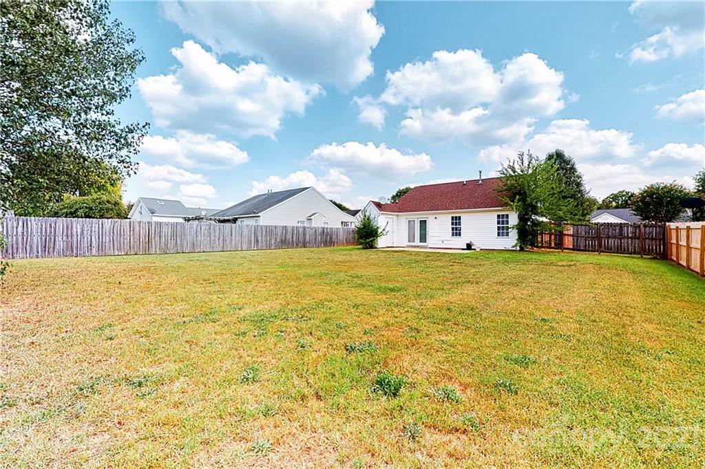 4262 Barley Street Southwest Concord, NC 28027 - Photo 25 of 27 a view of a swimming pool with a lawn chairs under an umbrella