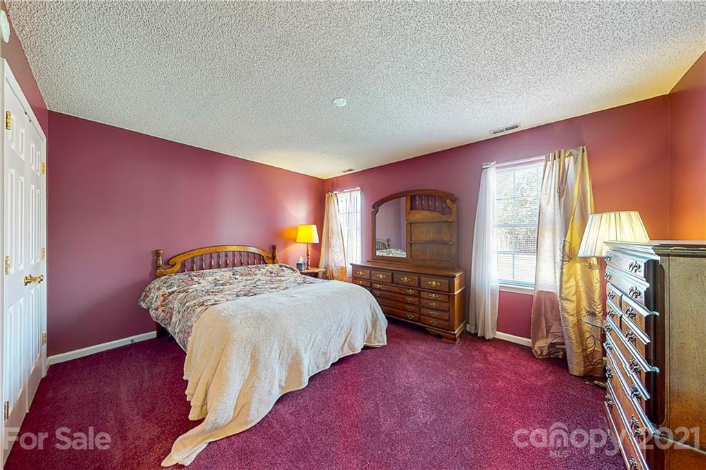 4262 Barley Street Southwest Concord, NC 28027 - Photo 9 of 27 a bed room with a bed and a tv