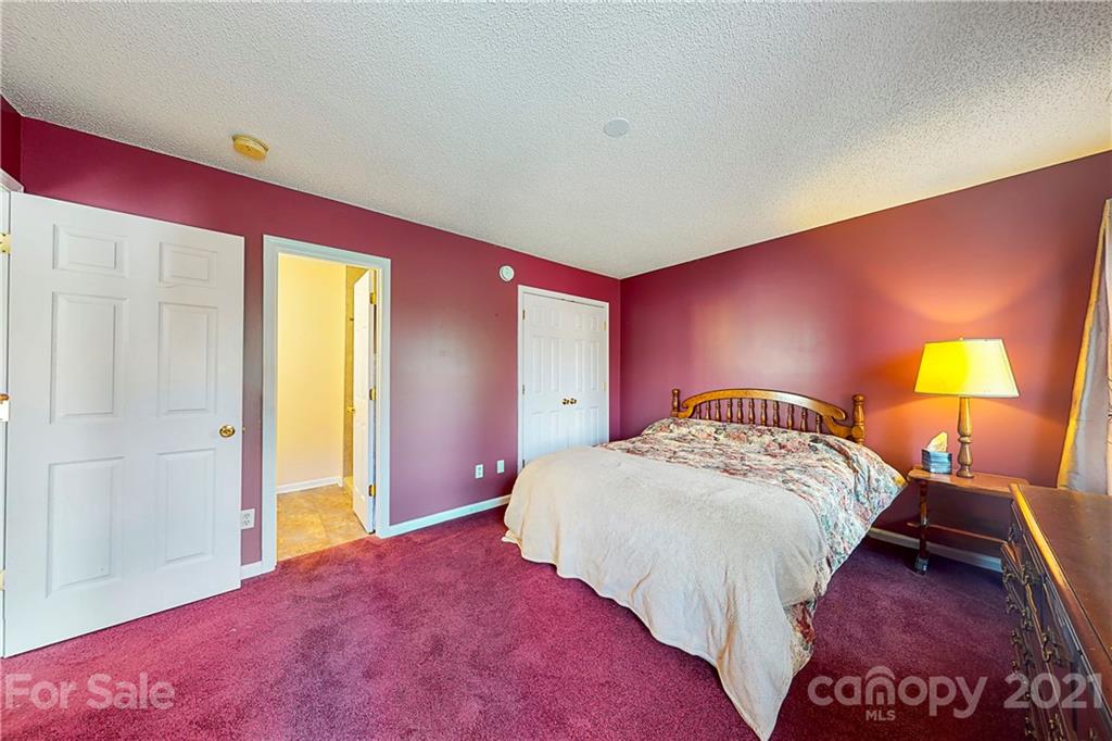 4262 Barley Street Southwest Concord, NC 28027 - Photo 10 of 27 a bedroom with a bed and a lamp