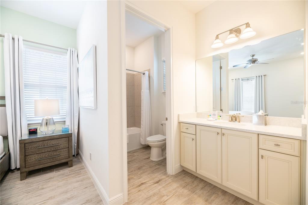 2956 Salted Rim Road Kissimmee, FL 34747 - Photo 12 of 12 a bathroom with a double vanity sink a toilet and a shower
